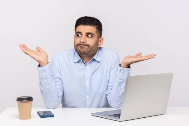 ing-office-workplace-with-laptop-on-desk-shrugging.webp
