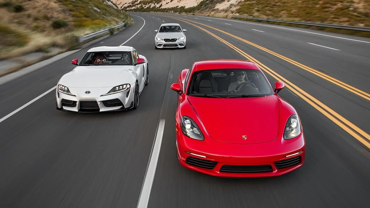 2020-Toyota-Supra-2018-Porsche-718-Cayman-2019-BMW-M2-Competition-front-motion-view-closer.webp