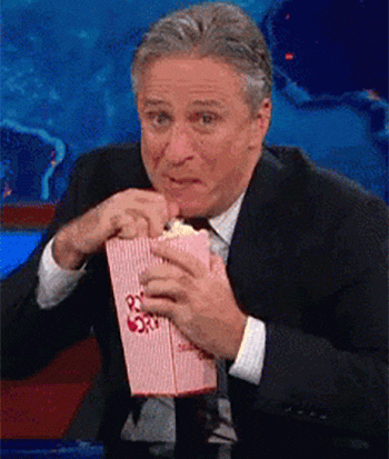5-john-stewart-having-fun-eating-popcorn.gif